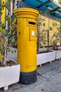Yellow Cypriot pillar box next to a parcel locker Royalty Free Stock Photo