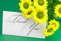 Yellow daisy and card signed thank you Royalty Free Stock Photo
