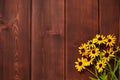 Yellow daisy flowers are on brown boards. Wooden background with beautiful pattern Royalty Free Stock Photo