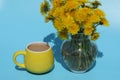 Yellow dandelions in the garden with cup of coffee Royalty Free Stock Photo