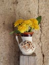 Beautiful yellow dandelions in a vase on the table, spring flowers, clear weather.