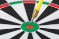 Yellow dart arrow hitting in the target center of dartboard Royalty Free Stock Photo