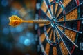 Yellow dart arrow hitting in the target center of dartboard with bokeh background Royalty Free Stock Photo