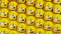 Yellow Daruma dolls on yellow background.