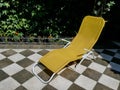 Yellow deck chair for relaxation on the terrace in the house yard