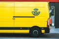 Yellow delivery van of Correos,the Mail Spanish postal company delivering on a public street