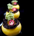 Yellow desserts with green pistachio sponge and cranberries