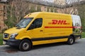 A yellow DHL courier service delivery van