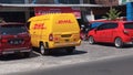 Yellow DHL courier van in front of a workshop (Indonesia-July 17, 2023)
