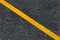 Yellow diagonal marking line on the asphalt road