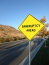 Yellow diamond road sign announcing bankruptcy ahead