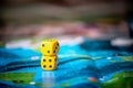Yellow dice game on the blue field of fantasy game. Luck and excitement. Board games strategy
