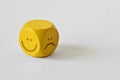 Yellow dice with positive and negative expression on white background