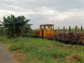 A Yellow Diesel Locomotive is Pulling Empty Carriages While Pushing Carriages Containing Sugar Cane Royalty Free Stock Photo