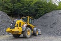 yellow digger with grey gravel for construction of the road Royalty Free Stock Photo