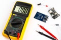 Yellow digital multimeter electronic measurement device tool with red and black cables microc chip circuit board led and micro Royalty Free Stock Photo