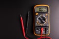 Yellow Digital multimeter with probes on black background , A multimeter is an electronic measuring instrument Royalty Free Stock Photo