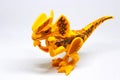 Yellow dinosaur toy on isolated white background