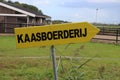 Yellow direction sign to a cheese farm in Dutch language Kaasboerderij in Nieuwerkerk aan den IJssel in the Netherlands