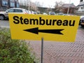 Yellow direction sign to polling station named stembureau in dutch for elections of the regional parlement in the Netherlands.