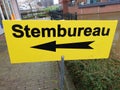 Yellow direction sign to polling station named stembureau in dutch for elections of the regional parlement in the Netherlands.