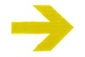 Yellow directional arrow manually painted on wooden signboard