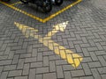 Yellow directional sign in the motorcycle parking area