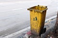 Yellow Dirty bin on street in metro city