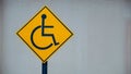 Yellow disable handicap parking sign board placed in a residential area. Royalty Free Stock Photo