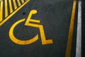 Yellow disabled parking symbol painted on asphalt Royalty Free Stock Photo