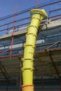 Yellow discharge chute construction debris