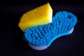 Yellow dish washing sponge and blue cleaning brush Royalty Free Stock Photo