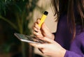 Yellow disposable electronic cigarette in a woman`s hand. Modern online communication Royalty Free Stock Photo