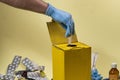 Yellow disposal box for contaminated or infectious products in a hospital or home Royalty Free Stock Photo