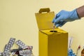 Yellow disposal box for contaminated or infectious products in a hospital or home Royalty Free Stock Photo