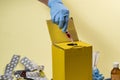 Yellow disposal box for contaminated or infectious products in a hospital or home Royalty Free Stock Photo