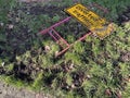 Yellow diverted traffic sign thrown away in the grass