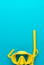 Yellow diving mask and snorkel over blue background with copy space Royalty Free Stock Photo
