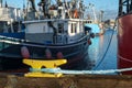 Yellow dock cleat with blue rope