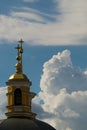 A yellow dome of a christian church against a blue sky Royalty Free Stock Photo