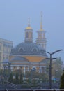 Yellow domes of Church of the Nativity at Pochtovaya square in Kyiv. Mysterious misty landscape. Beautiful wallpaper of foggy Kyiv Royalty Free Stock Photo