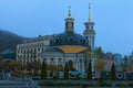 Yellow domes of Church of the Nativity at Pochtovaya square in Kyiv. Mysterious misty landscape