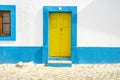 Yellow door in traditional portuguese house painted on blue and white Royalty Free Stock Photo