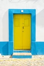 Yellow door in traditional portuguese house painted on blue and white Royalty Free Stock Photo