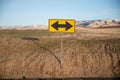 Yellow double arrow sign in the desert