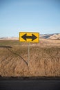 Yellow double arrow sign in the desert