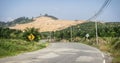 Yellow double curve sign in a deserted street with repaired potholes. Road trip travel concept. In Phang Nga, Thailand