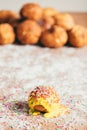 Yellow doughnut decorated with sugar strands