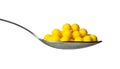 Yellow dragee with vitamins in spoon isolated Royalty Free Stock Photo