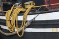 Yellow draped rope to a fishing boat Royalty Free Stock Photo